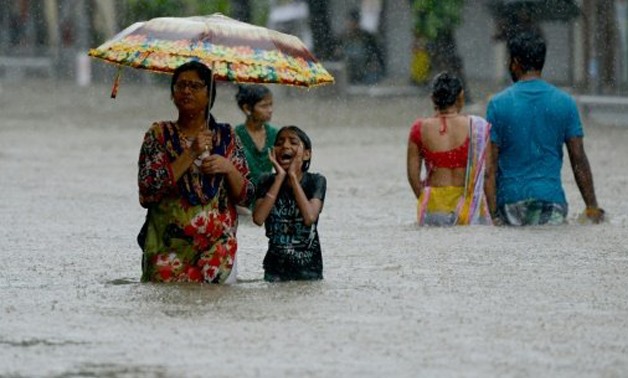  Days of intense monsoon downpours have deluged the densely-populated city of more than 20 million, paralysing crucial local train services and leaving commuters to wade through swirling waist-high waters
AFP / by Vishal MANV