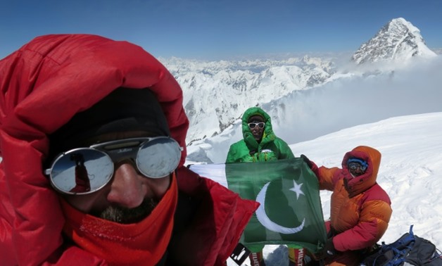 Veteran climber Oscar Cadiach (C) after summiting the 8,051-metre Broad Peak in northern Pakistan, at the end of a 33-year career risking life and limb to conquer some of the world's most unforgiving terrain

