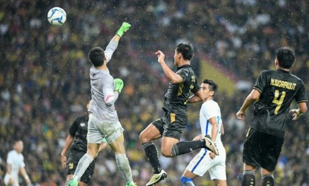 AFP | Malaysia's goalkeeper Haziq Nadzli punches the ball into his own net for the only goal of the men's final between Thailand and Malaysia at the Southeast Asian Games