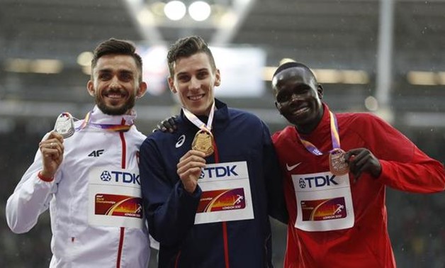 Adam Kszczot of Poland (silver), Pierre-Ambroise Bosse of France (gold) and Kipyegon Bett of Kenya (bronze) pose with the medals. REUTERS/Matthew Childs