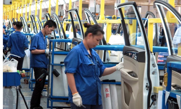 FILE PHOTO - Employees work at a production line inside a factory of Saic GM Wuling, in Liuzhou, Guangxi Zhuang Autonomous Region, China- Reuters