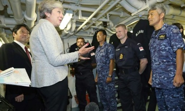 © JIJI PRESS/AFP | Britain's Prime Minister Theresa visited helicopter carrier Izumo at a base in Yokosuka before attending Japan's top security meeting
