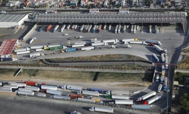 © GETTY/AFP/File / by Yussel GONZALEZ | Freight trucks snake from Mexico into California as they are inspected at US Customs, at the Otay Mesa port of entry in San Diego
