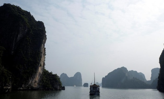 A cruise sails along Halong Bay, a Unesco World Heritage Site, in Quang Nam province - REUTERS