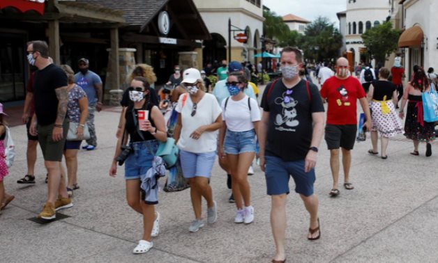 Disney Springs shoppers wear face masks and Disney-themed clothing while Walt Disney World conducts a phased reopening from coronavirus disease restrictions in Lake Buena - July 11, 2020. REUTERS/Octavio Jones