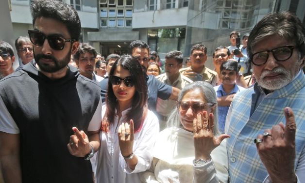 Bollywood star Amitabh Bachchan, son Abhishek Bachchan, Aishwarya Rai Bachchan and Jaya Bachchan show ink marks on their fingers after casting their votes-REUTERS/Francis Mascarenhas