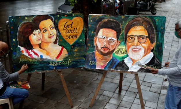 Artists create paintings depicting Bollywood actor Amitabh Bachchan, his son Abhishek Bachchan, his daughter-in-law Aishwarya Rai Bachchan and his granddaughter Aaradhya  - REUTERS/Francis Mascarenhas