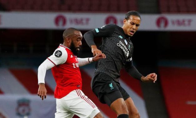 Lacazette in action with Liverpool's Virgil van Dijk, as play resumes behind closed doors following the outbreak of the coronavirus disease (COVID-19) REUTERS / Paul Childs / Pool