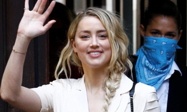 Actor Amber Heard waves as she arrives at the High Court in London, Britain July 20, 2020. REUTERS/Henry Nicholls