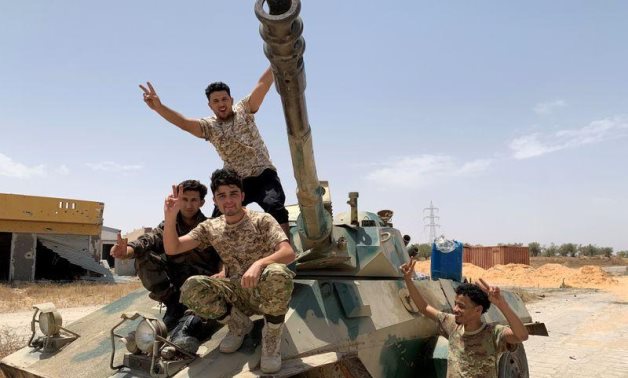 FILE PHOTO: Fighters loyal to Libya's Government of National Accord (GNA) celebrate after regaining control over the city, in Tripoli, Libya, June 4, 2020. REUTERS/Ayman Al-Sahili