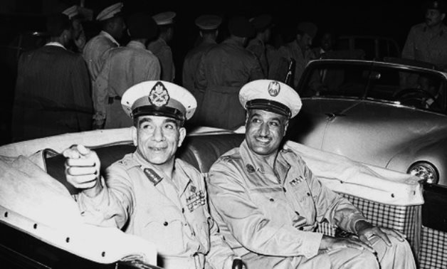 Prime Minister Gamal Abdel Nasser (right) and President Mohammed Naguib (left) in an open-top automobile during celebrations marking the second anniversary of the Egyptian Revolution of 1952 - Wikipedia commons