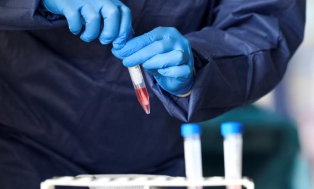 FILE PHOTO: A member of medical staff takes coronavirus test samples during drive-thru coronavirus disease (COVID-19) testing, on a converted ice rink, in Alkmaar, Netherlands April 8, 2020.- Reuters