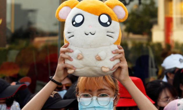 FILE PHOTO: A demonstrator holds a soft toy "Hamtaro" during a protest demanding the resignation of Thailand's Prime Minister Prayuth Chan-o-cha, in Bangkok July 26, 2020. REUTERS/Jorge Silva/File Photo