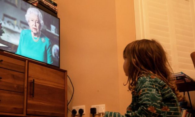 FILE PHOTO: Isaac (4) watches Queen Elizabeth II during a televised address to the nation, London, Britain, April 5, 2020. REUTERS/Simon Dawson/File Photo