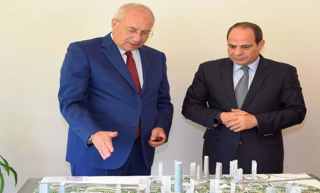 FILE - Egypt's President Abdel Fattah El Sisi listens as Yehia Zaki explains development of the New Administrative Capital