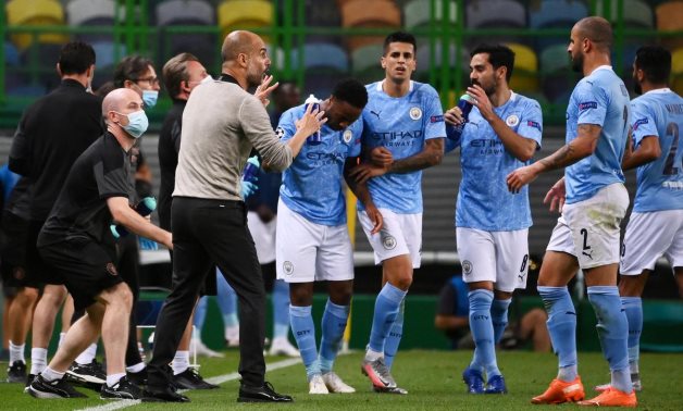 Manchester City manager Pep Guardiola with his players, as play resumes behind closed doors following the outbreak of the coronavirus disease (COVID-19) Franck Fife/Pool via REUTERS