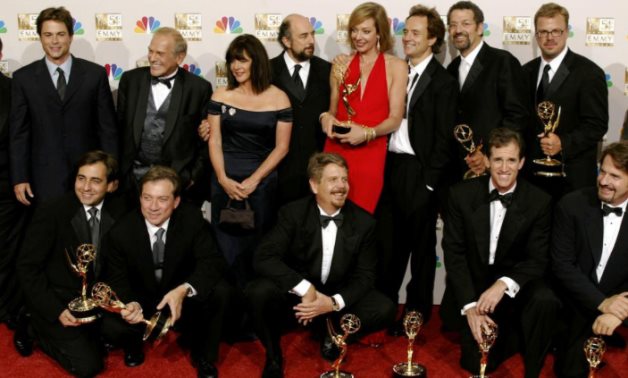 FILE PHOTO: The cast and crew of "The West Wing" show off all of their numerous Emmys at the 54th annual Emmy Awards in Los Angeles September 22, 2002. REUTERS/Mike Blake/File Photo