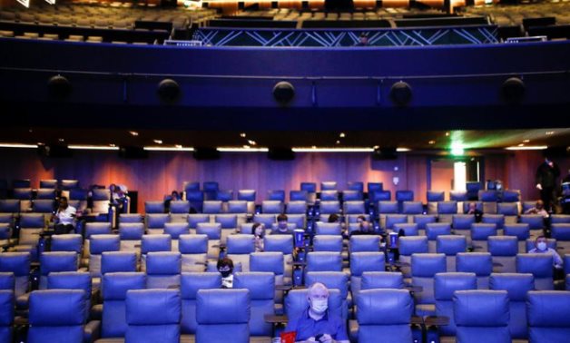 People take their seats inside the Odeon Luxe Leicester Square cinema, on the opening day of the film "Tenet", amid the  (COVID-19) outbreak, in London, Britain, August 26, 2020. REUTERS/Henry Nicholls