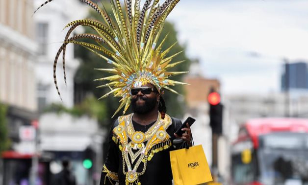 A festival goer dances in the street after the normal Notting Hill Carnival festivities was cancelled amid the coronavirus disease (COVID-19) outbreak, in London, Britain, August 31, 2020. REUTERS/Toby Melville