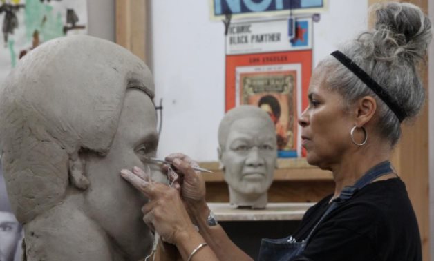 Sculptor Dana King works on her latest statue, Black Panther Party co-founder Huey P. Newton, in her studio in Oakland, California, U.S., September 1, 2020. REUTERS/Nathan Frandino