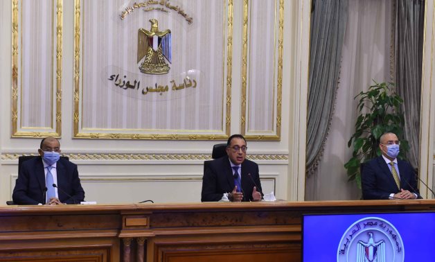 Egypt’s Prime Minsiter Mustafa Madbouli (middle) speaks in a press conference attended by a number of ministers including the housing minister (R) and the local development minister – Cabinet