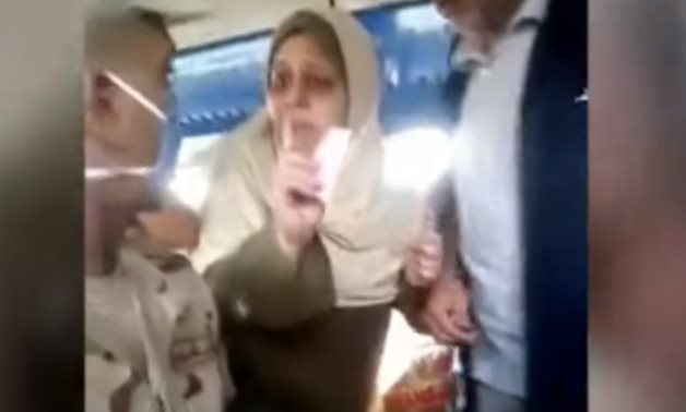 A woman in the train swearing she won't take money from the conscript after paying for his ticket - Youtube still