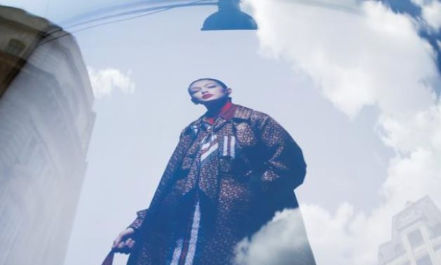 FILE PHOTO: An advertisement containing a jacket with Burberry logo pattern is pictured at a window of a Burberry store in central London, Britain July 12, 2019. REUTERS/Henry Nicholls