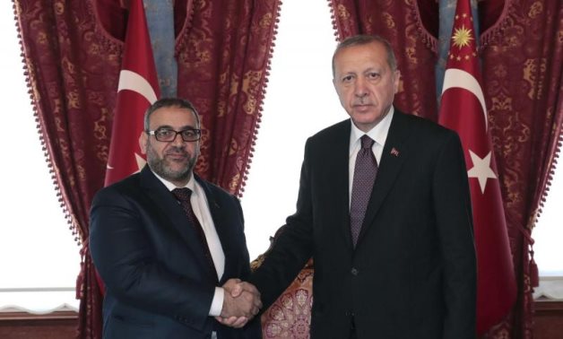 Turkish President Recep Tayyip Erdogan, right, and Khaled Al-Meshri, President of the High Council of State of Libya, shake hands before a meeting, in Istanbul, Friday, April 19, 2019. (AP)