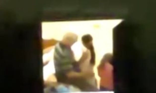 A teacher was arrested after a video showing him harassing a girl and kissing her in a room - Screenshot of video