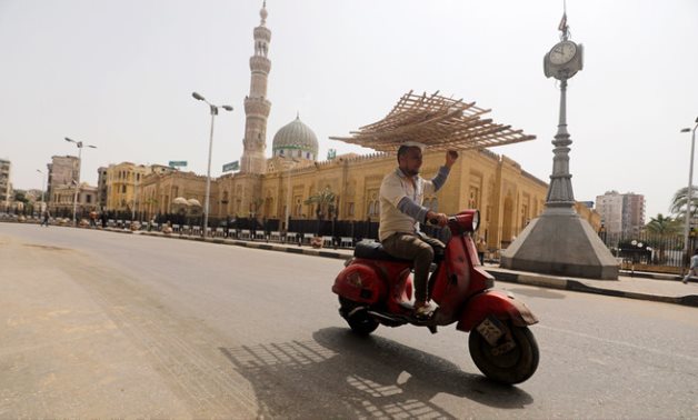 A man travels on a scooter past the closed El-Sayeda Zainab Mosque in Cairo. (Reuters)