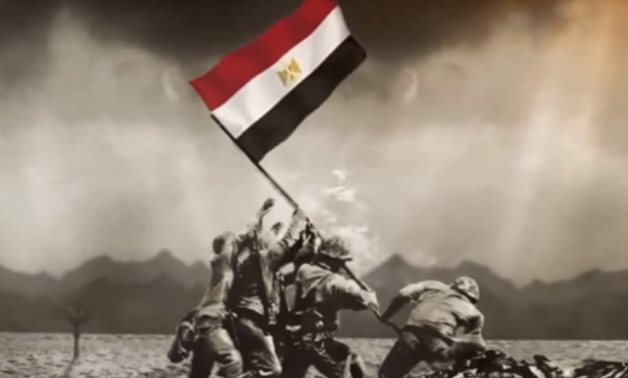 FILE - Egyptian soldiers raise the Egyptian flag high in the sky during the October Victory