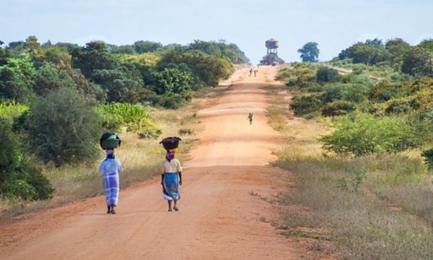 African women walking along road- CC via Pixabay/jeanvdmeulen