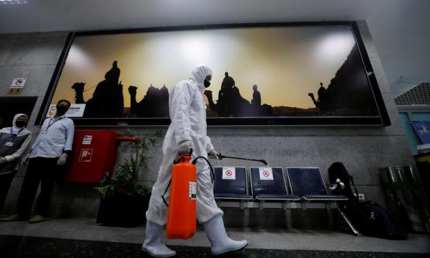 A worker wears protective gear as he sprays disinfectant at Hurghada International Airport in Hurghada, Egypt, June 18, 2020. Reuters/Mohamed Abd El Ghany