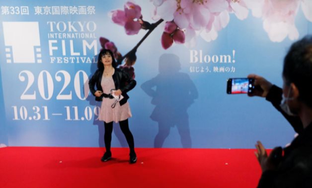 Visitors take photo on the red carpet at an entrance gate of the the 33rd Tokyo International Film Festival, amid the (COVID-19) outbreak, in Tokyo, Japan October 31, 2020. REUTERS/Issei Kato