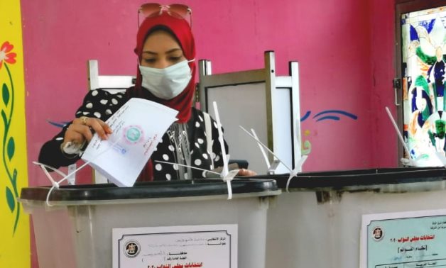 FILE - Woman casts ballot in Egypt's House of Representatives elections 