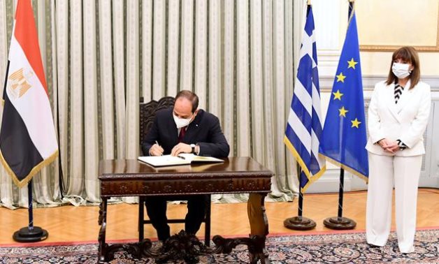 FILE- President Abdel Fattah El Sisi signs an agreement with Greece in Athens, on November 2020- press photo