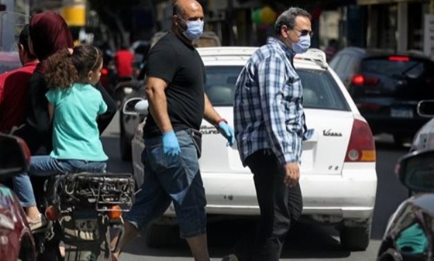 FILE - Men wearing protective face masks walk in downtown Cairo, amidst concerns about the spread of the coronavirus disease (COVID-19), Egypt, May 2, 2020. REUTERS/Mohamed Abd El Ghany