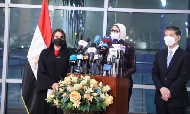 Egyptian Health Minister speaks in a press conference, along with Chinese Ambassador to Egypt and acting Emirati Ambassador Mariam Al-Kaabi, after the arrival of the 1st batch of the vaccine at Cairo Airport