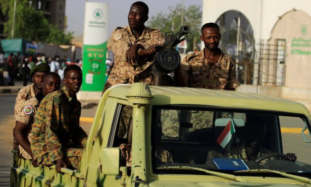Sudanese soldiers driving an army vehicle in the capital Khartoum - Reuters