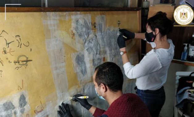 Experts working on the mural - photo via Egypt's Min. of Tourism & Antiquities 