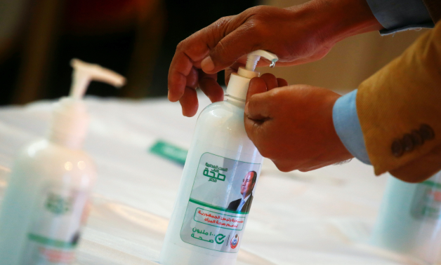 File- An image depicting Egyptian President Sisi is seen on a bottle of sanitiser before a news conference announcing the details of a vaccination campaign against the coronavirus, in Cairo 2020. REUTERS