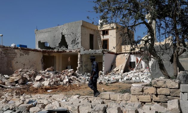 A security member inspects the site of an overnight air strike, which hit a residential district in Tripoli, Libya October 14, 2019. REUTERS/Ismail Zitouny