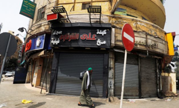 A man walks past closed shops following the spread of coronavirus disease (COVID-19), in old Islamic Cairo, Egypt, March 27, 2020. (Photo: Reuters)