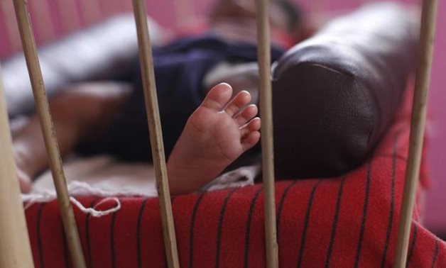 A baby girl is seen lying in a cradle inside the Life Line Trust orphanage in Salem in the southern Indian state of Tamil Nadu June 20, 2013. Thomson Reuters Foundation/Mansi Thapliyal