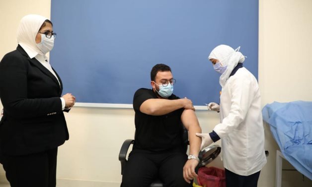 FILE - Egypt vaccinates the first doctor included in the Health Ministry’s anti-coronavirus campaign, January 24 - Egyptian Health Ministry