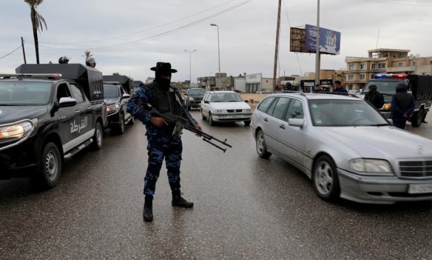 FILE PHOTO: A member of the central security support force holds a weapon during a security deployment in the Tajura neighborhood, east of Tripoli, Libya December 30, 2019. REUTERS