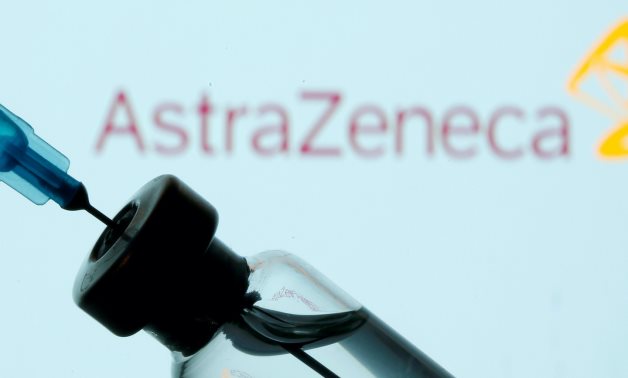FILE PHOTO: A vial and syringe are seen in front of a displayed AstraZeneca logo in this illustration taken January 11, 2021. REUTERS/Dado Ruvic/Illus