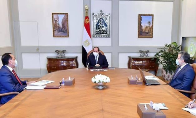 File: President Abdel Fattah El Sisi,prime minister Mostafa Madbouly and minister of tourism and antiquites Khaled El Enany.