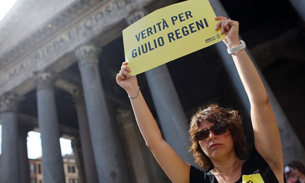 FILE - An international activist holds a placard reading "truth for Giulio Regeni" in Rome - Reuters
