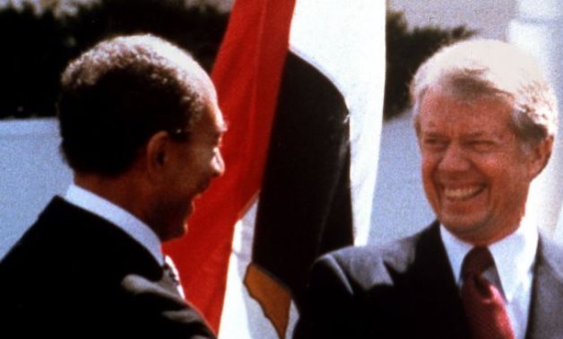 Egyptian President Anwar Sadat, left, US President Jimmy Carter, right, during the latter's visit to Egypt in 1979 - (photo credit: AP/Bob Daugherty/File)